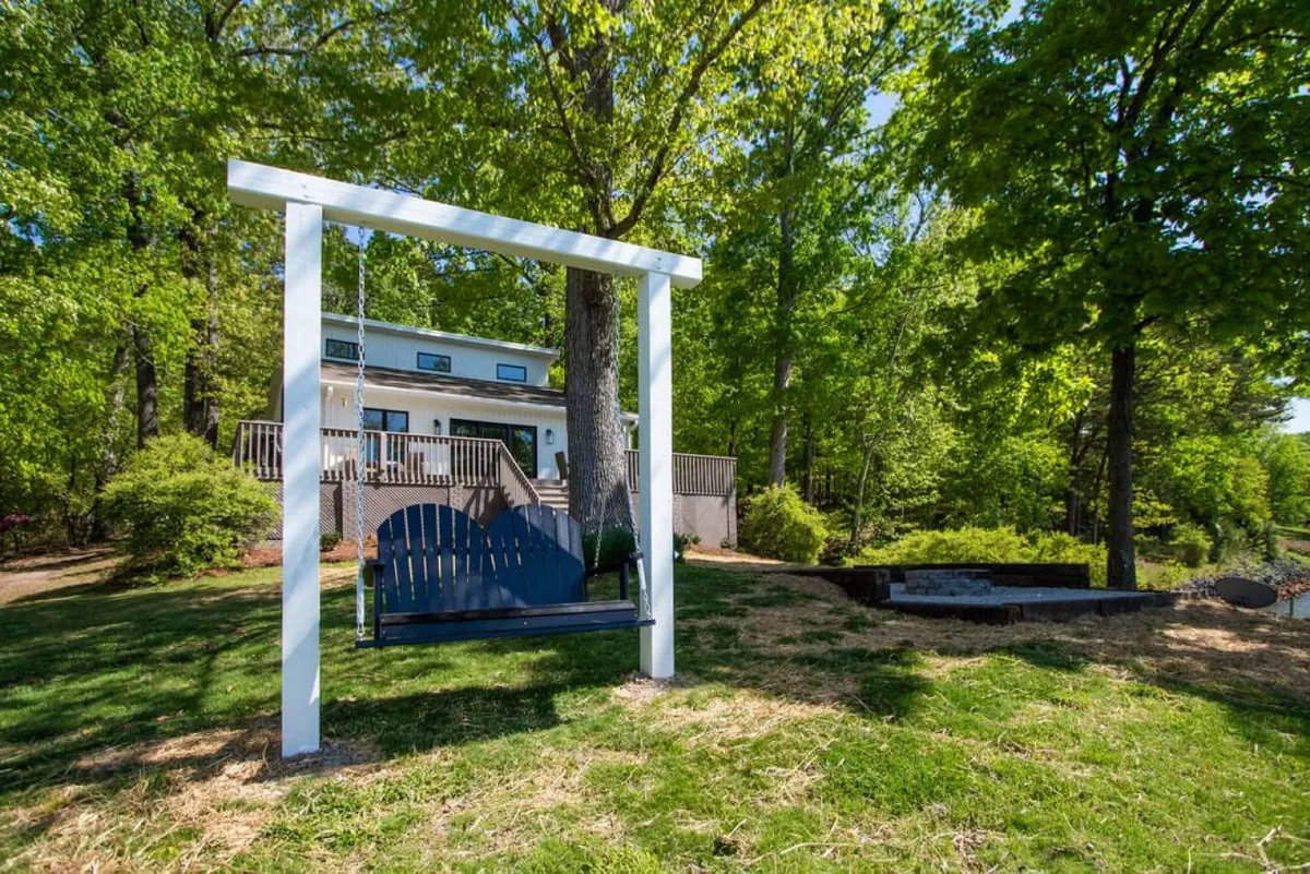 This lively exterior scene features a swing in the yard, the house in the background, and lush greenery, evoking a sense of play and outdoor family fun. The joyful mood highlights opportunities for children and families to enjoy time together in the fresh air.